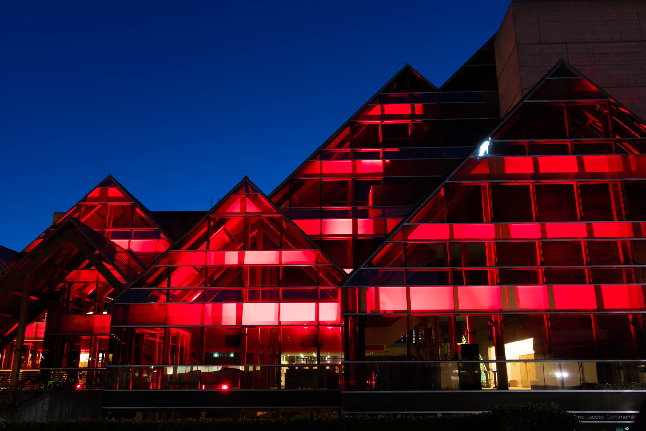 Outside of the Hult Center lit up with red lights