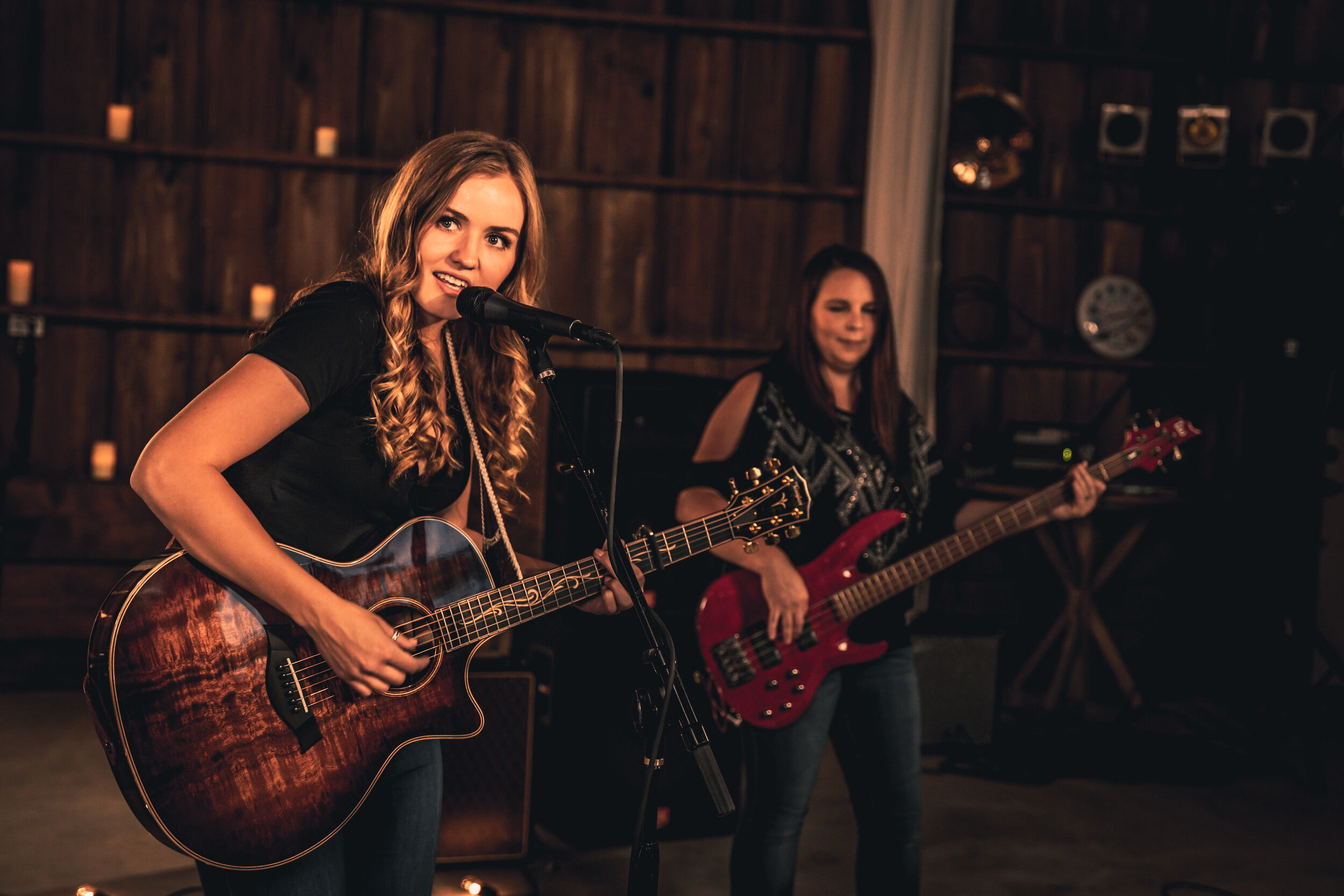 Image of McKayla Marie playing guitar on stage with bassist