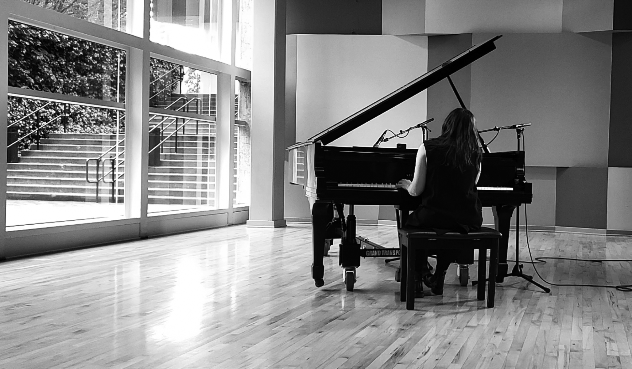 Black and White Photo of Emily Wells playing the piano